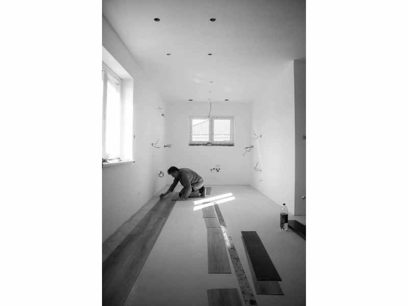 laying laminate flooring Man laying laminate flooring