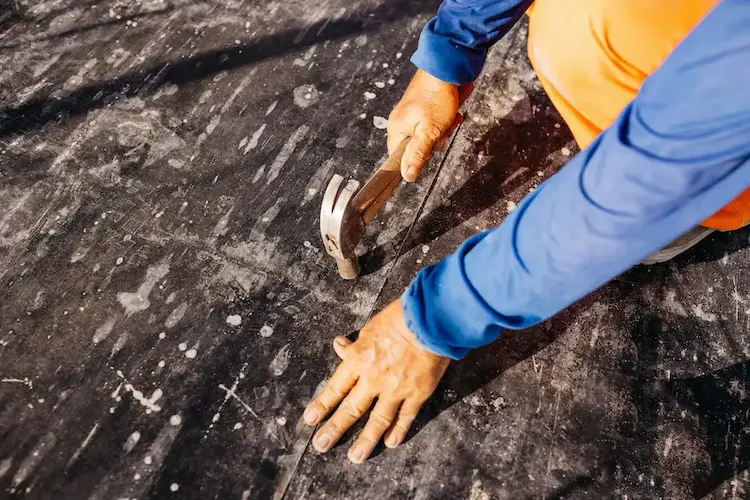 roof leak fix Man fixing roof leak